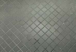 Ceramic tile in restroom before being polished by International Stoneworks. Ceramic tile restoration of restroom floor