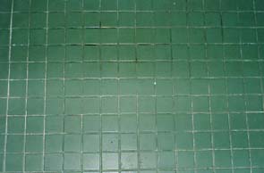 Restroom ceramic tile before restoration by International Stoneworks Green Ceramic Tile Before Restoration of Restroom