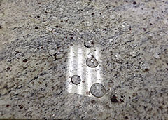Sealed granite tile with water droplets 